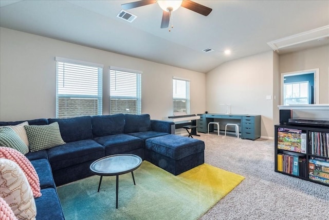 living room with ceiling fan, carpet flooring, and vaulted ceiling