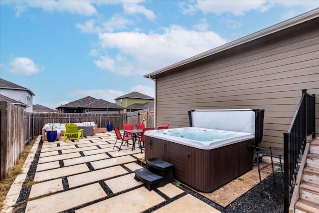 view of patio / terrace with a hot tub and an outdoor living space