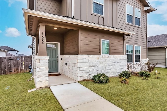 122 Fairmeadow Downs Dr, Hutto, TX 78634 - entrance to property featuring fence, stone siding, board and batten siding, and a yard