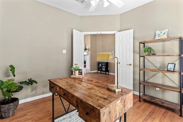 office space with ceiling fan and light hardwood / wood-style flooring