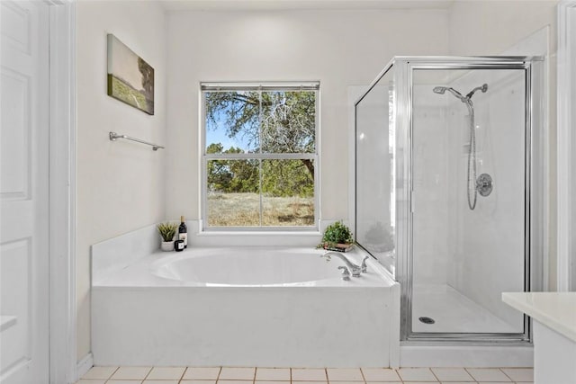 bathroom featuring a healthy amount of sunlight, separate shower and tub, and tile patterned flooring