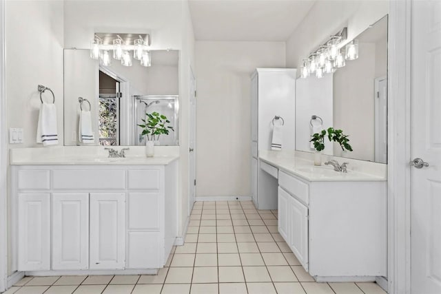 bathroom with tile patterned floors, vanity, and an enclosed shower