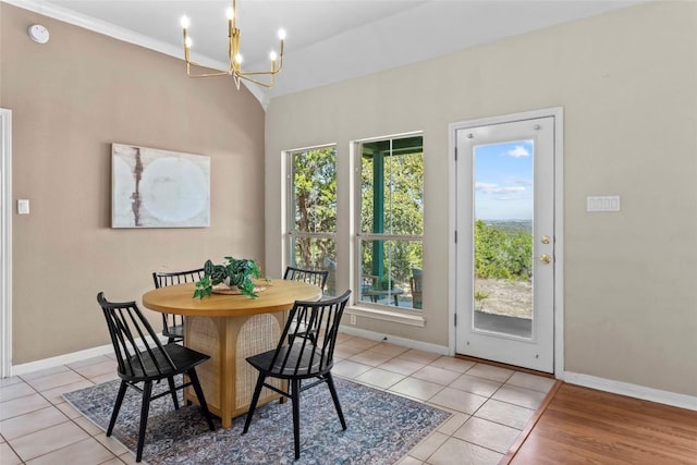 1001 Springlake Dr, Dripping Springs, TX 78620 - dining space featuring healthy amount of natural light, a chandelier, baseboards, light tile patterned flooring, and vaulted ceiling