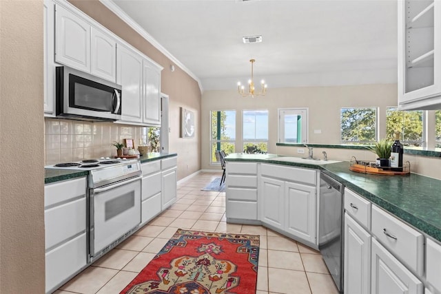 1001 Springlake Dr, Dripping Springs, TX 78620 - kitchen featuring appliances with stainless steel finishes, white cabinetry, a chandelier, dark countertops, and crown molding