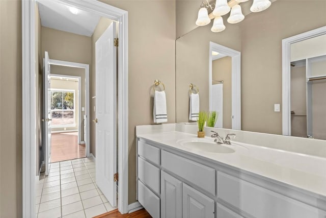 1001 Springlake Dr, Dripping Springs, TX 78620 - bathroom featuring vanity, a chandelier, and tile patterned flooring