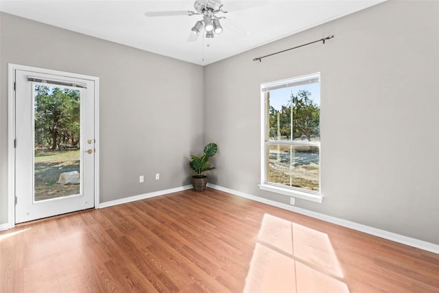 unfurnished room with hardwood / wood-style floors and ceiling fan