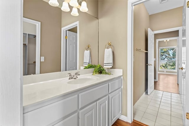 1001 Springlake Dr, Dripping Springs, TX 78620 - bathroom featuring vanity, a chandelier, tile patterned floors, and baseboards