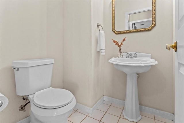 bathroom with tile patterned floors and toilet