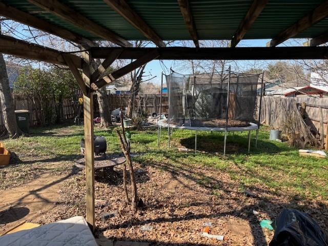 view of yard with a trampoline