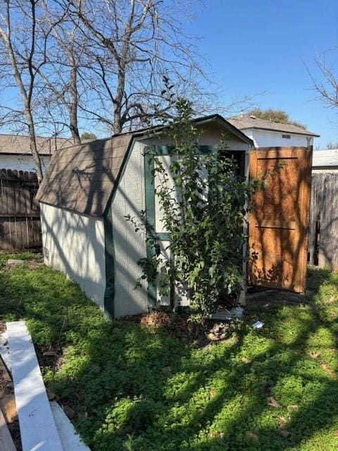 view of property exterior with a yard and a storage shed