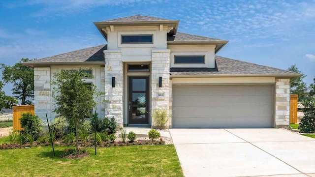 1412 Snowdrop Dr, Georgetown, TX 78628 - view of front of home with roof with shingles, stone siding, a front lawn, a garage, and concrete driveway