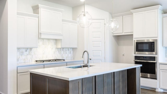 1412 Snowdrop Dr, Georgetown, TX 78628 - kitchen featuring stainless steel appliances, light countertops, decorative backsplash, and a center island with sink