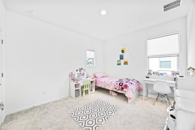 bedroom with light colored carpet