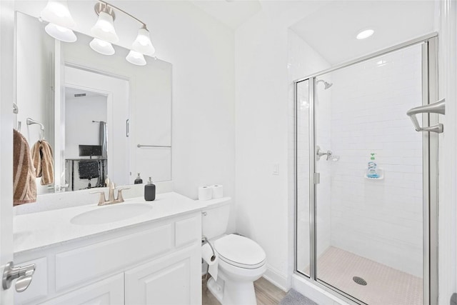 bathroom with vanity, toilet, and an enclosed shower