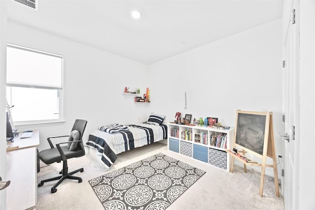 bedroom featuring light carpet