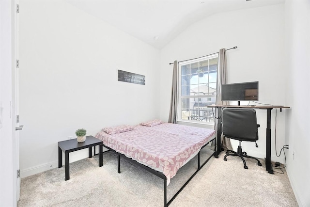 carpeted bedroom with vaulted ceiling