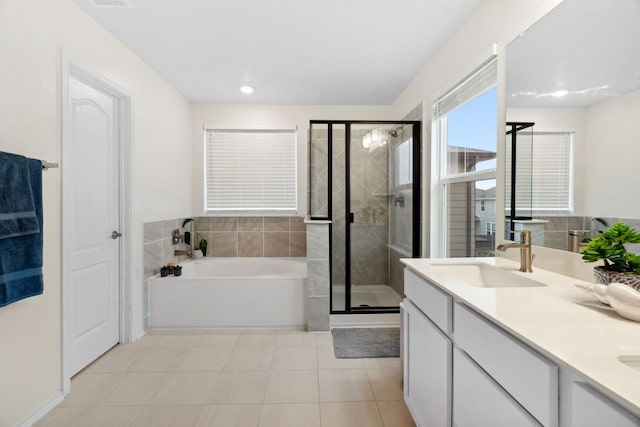 bathroom with independent shower and bath, vanity, and tile patterned flooring