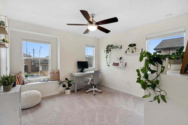 office space with carpet flooring, a wealth of natural light, and ceiling fan