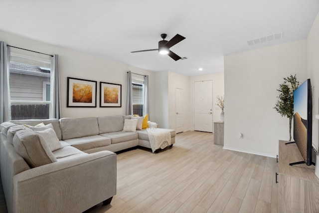 living room featuring ceiling fan and light hardwood / wood-style floors