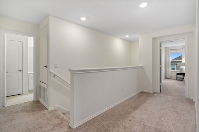 hallway featuring light carpet