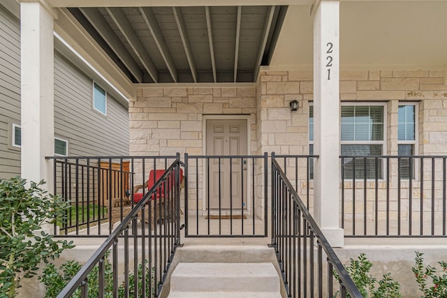 doorway to property with stone siding