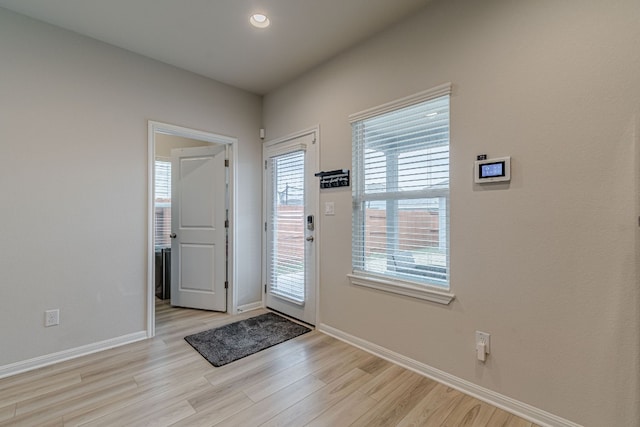 entrance foyer with recessed lighting, baseboards, and light wood finished floors