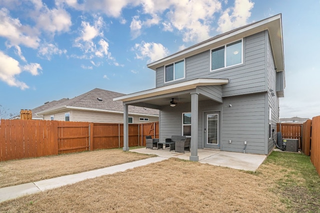 rear view of house featuring a ceiling fan, a yard, a fenced backyard, and a patio