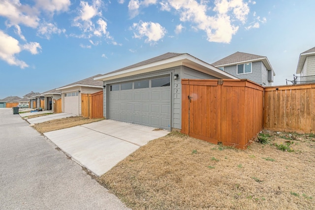 view of front of property featuring fence and concrete driveway