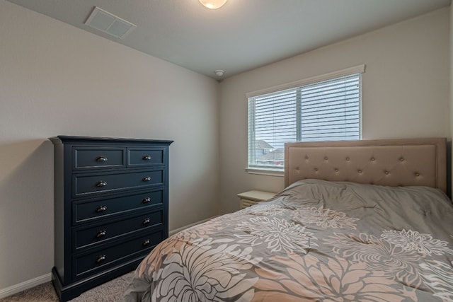 bedroom with carpet, visible vents, and baseboards