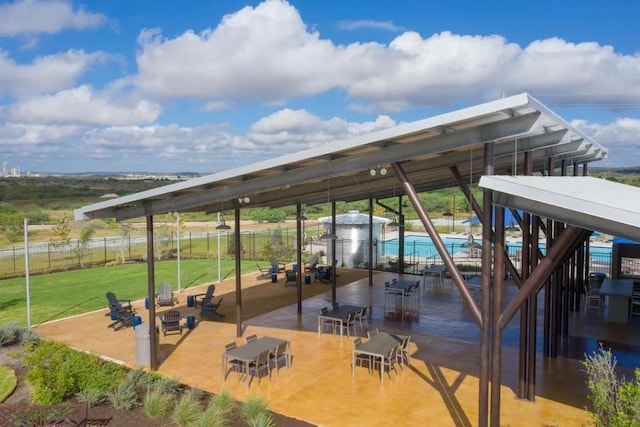 exterior space with a patio, a swimming pool, and fence