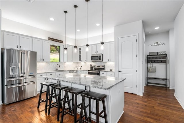 712 Newport Dr, Spicewood, TX 78669 - kitchen featuring stainless steel appliances, dark wood finished floors, decorative backsplash, and a sink
