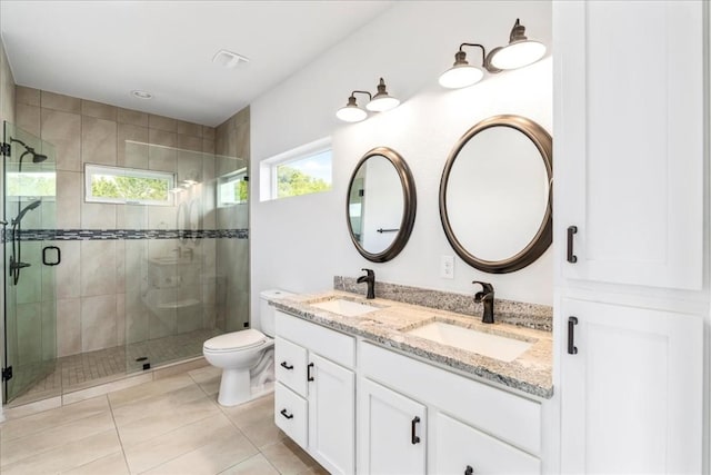 full bath featuring tile patterned floors, a sink, a shower stall, and double vanity