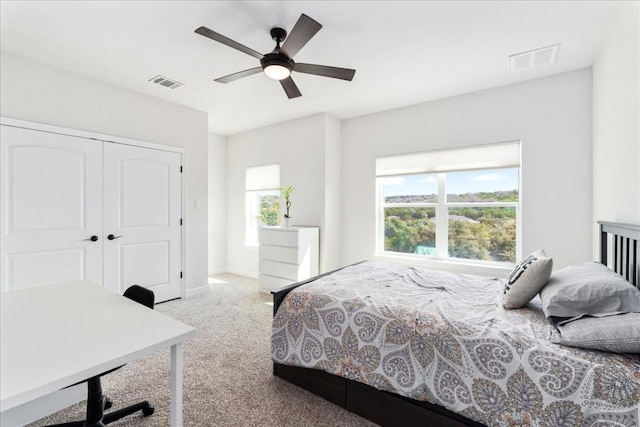 bedroom featuring carpet floors, a closet, visible vents, and a ceiling fan