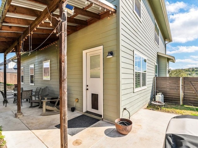 entrance to property with fence and a patio