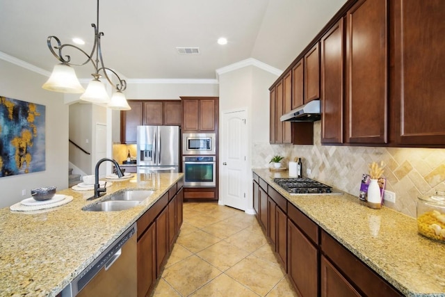 kitchen with pendant lighting, sink, decorative backsplash, stainless steel appliances, and light stone countertops