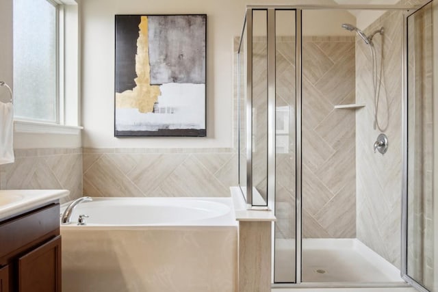 bathroom featuring vanity and independent shower and bath