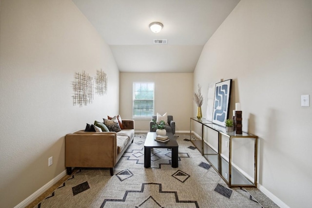 carpeted living room with baseboards, visible vents, and vaulted ceiling