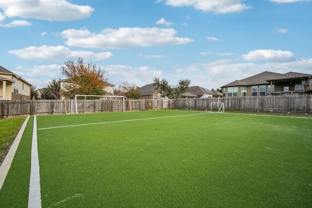 view of yard featuring fence and a residential view