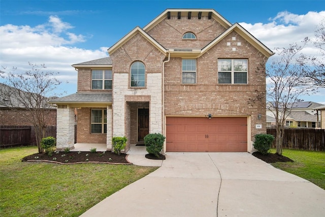 traditional-style house featuring a garage, fence, concrete driveway, and a front yard