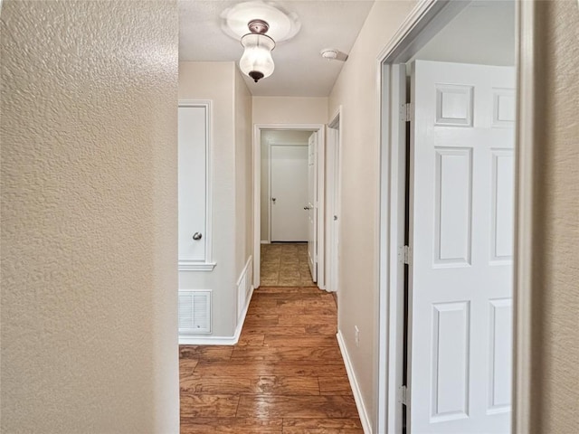 hall with hardwood / wood-style floors