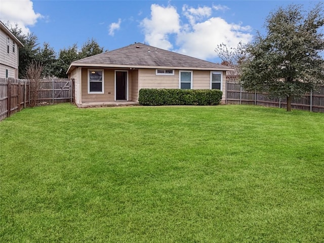 back of house with a patio and a yard