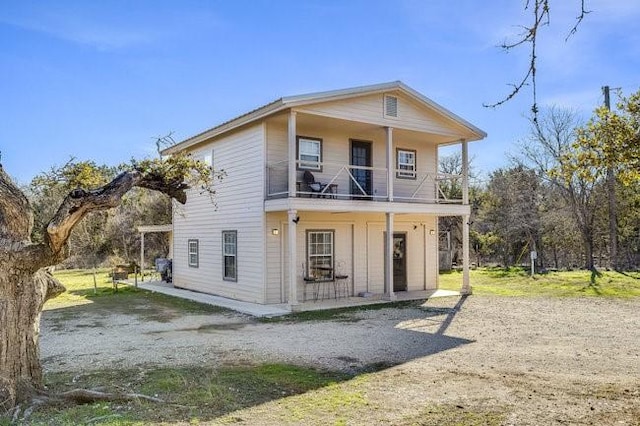 rear view of house featuring a balcony