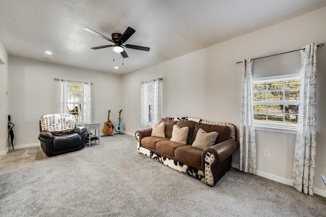 carpeted living room featuring ceiling fan