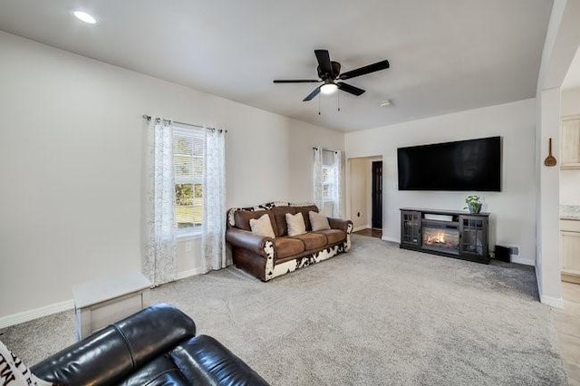 living room featuring ceiling fan and light colored carpet