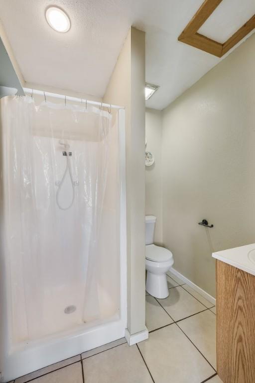 bathroom featuring tile patterned flooring, vanity, and a shower with shower curtain