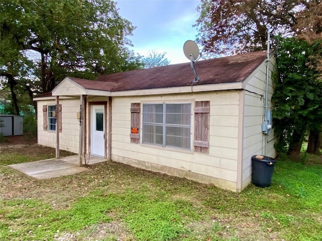 rear view of house with a lawn