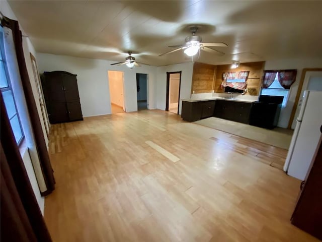 kitchen with light hardwood / wood-style flooring, ceiling fan, and white refrigerator