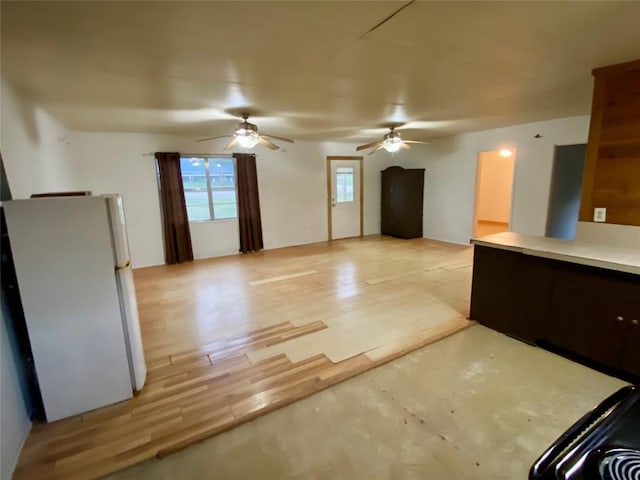 kitchen with light hardwood / wood-style flooring, ceiling fan, and white refrigerator