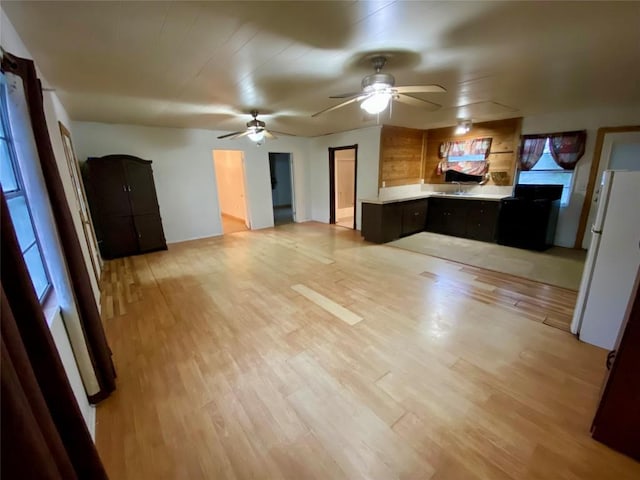 interior space featuring ceiling fan and light hardwood / wood-style flooring