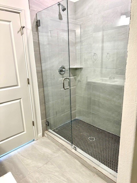 bathroom featuring a shower with door